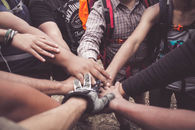 People doing group hand cheer