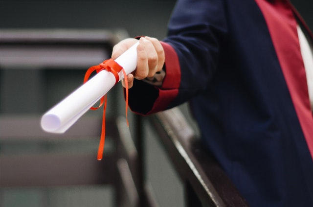 Certificate scroll being handed to graduate